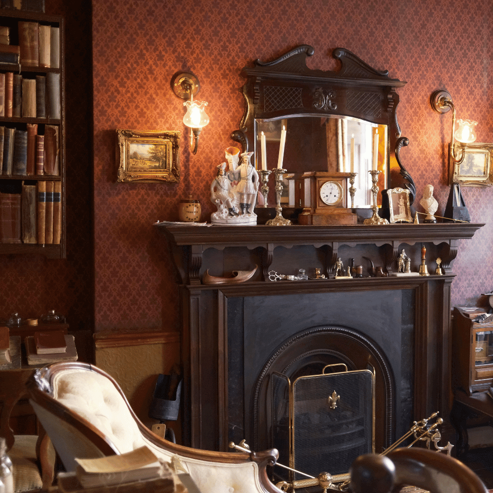 A fireplace with a mantle and vintage mirror, surrounded by vintage decor