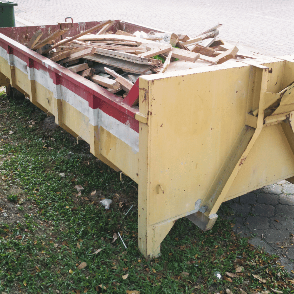 A yellow dumpster on a sidewalk