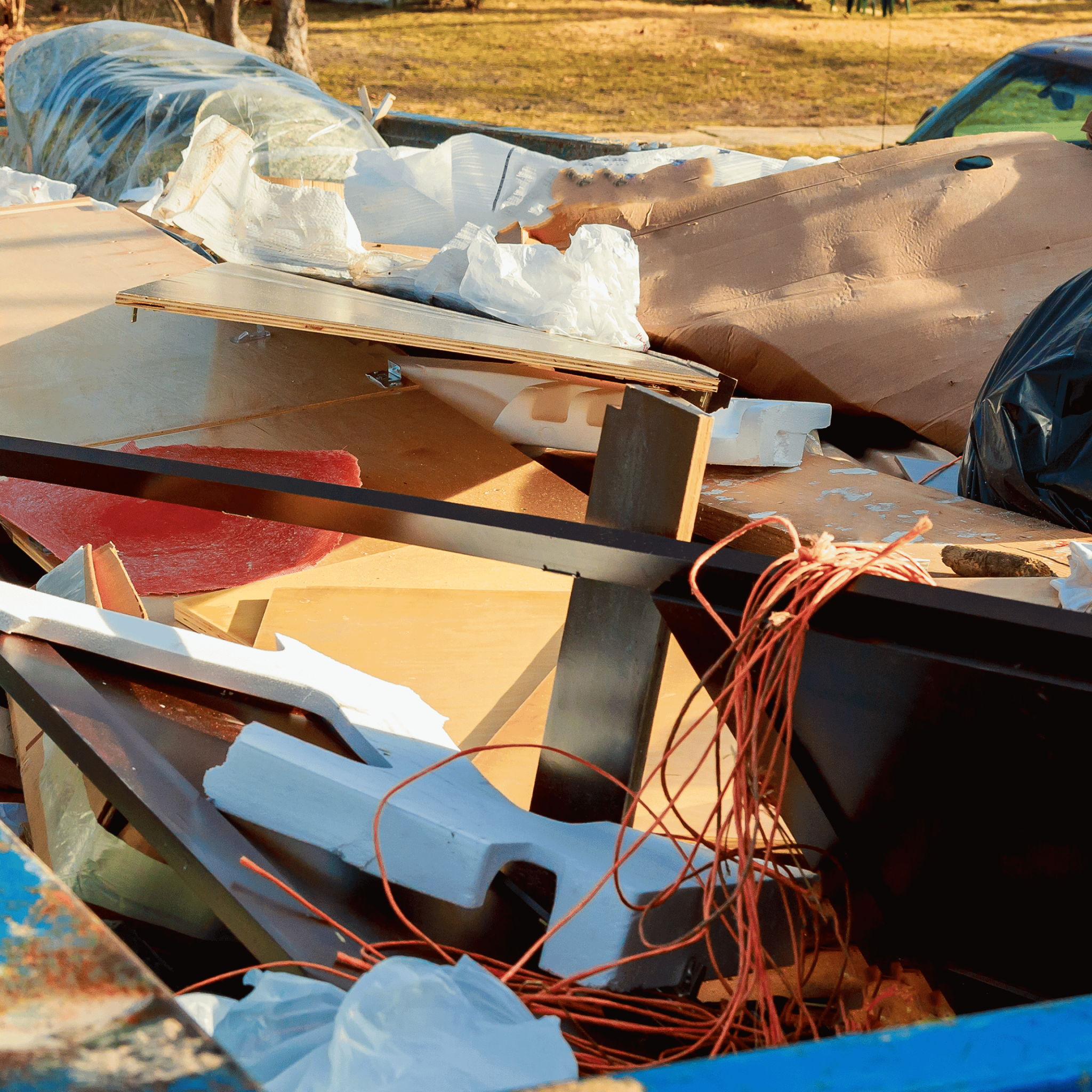 Junk in a blue dumpster
